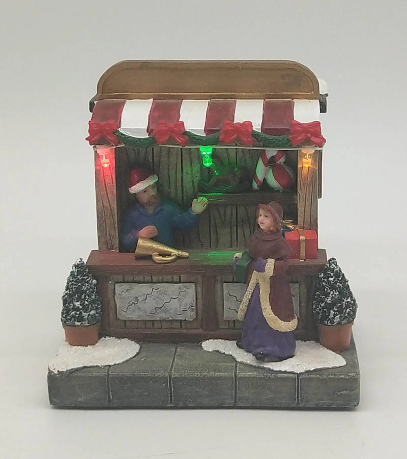 Rozświetlony świąteczny sklep z zabawkami z kobietą