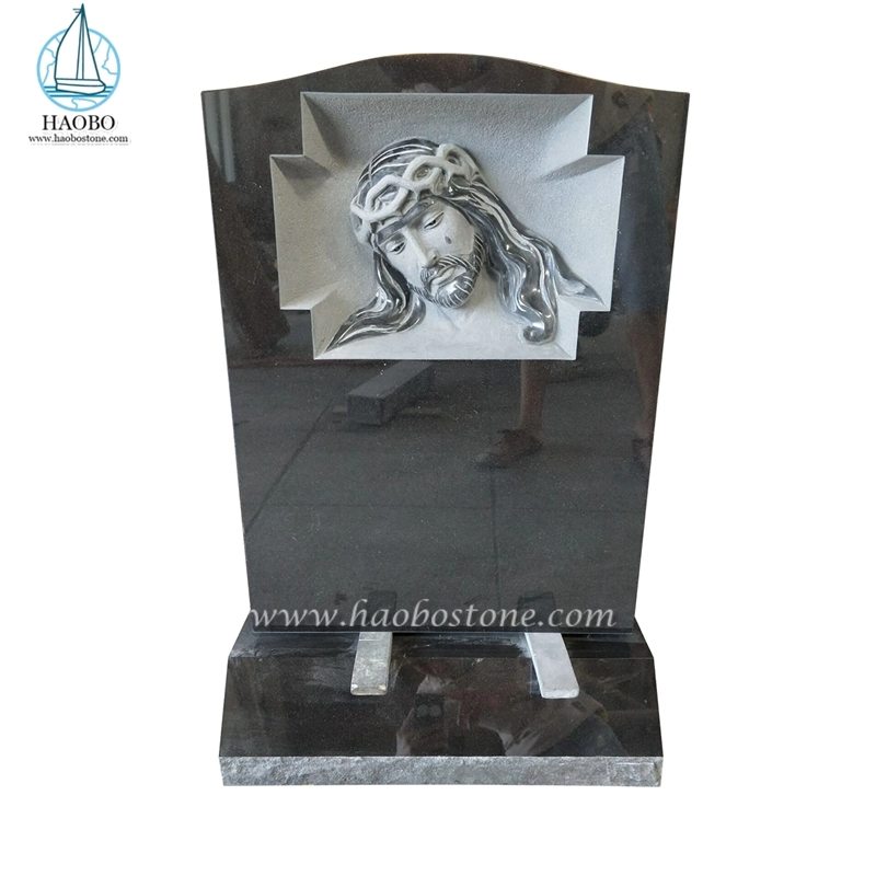 Czarny granitowy nagrobek płaczącego Jezusa z wygrawerowanym nagrobkiem